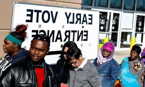 Voters stand outside an early voting poll entrance